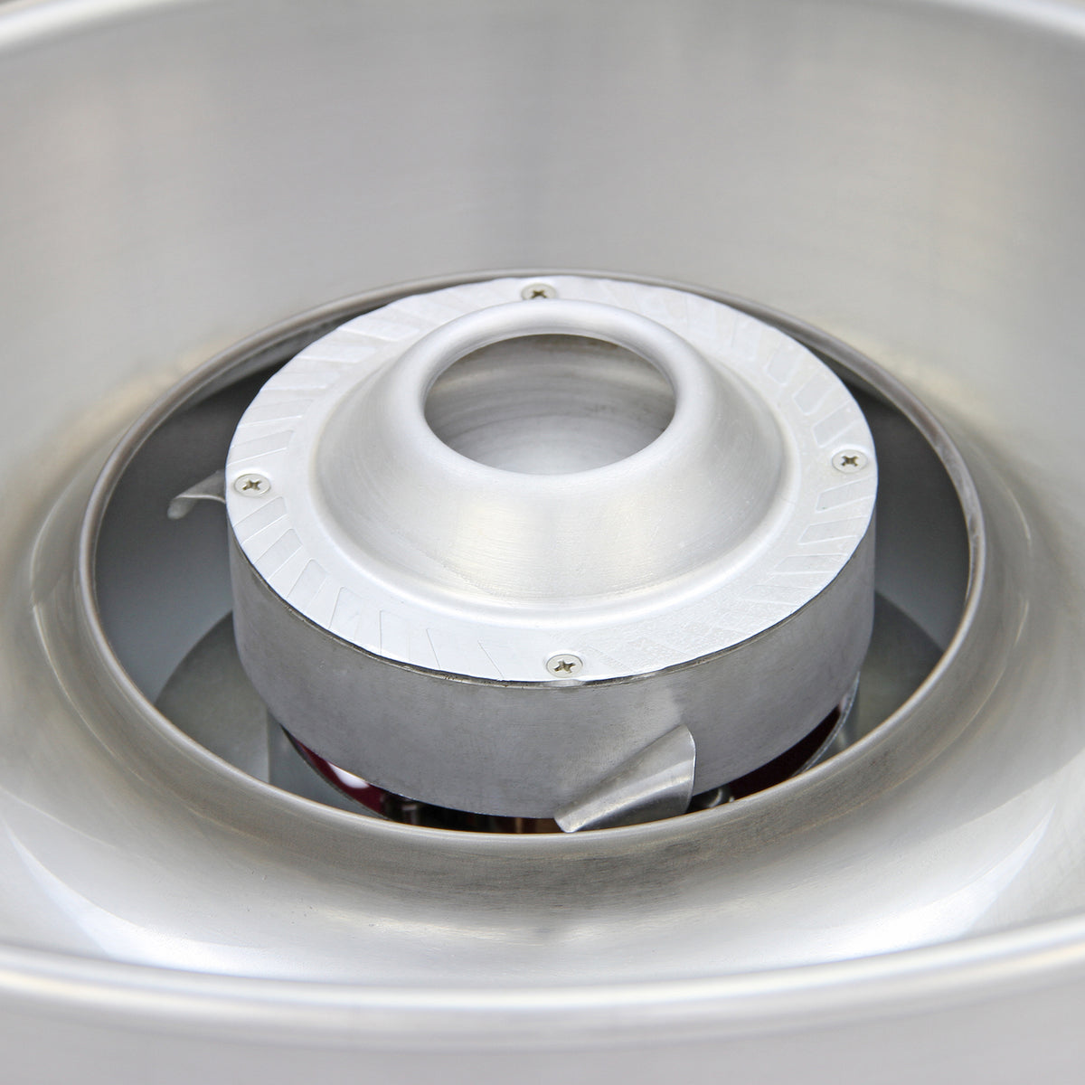 Close-up of a shiny stainless steel turbine with a smooth, rounded center and textured edges, designed for efficient airflow