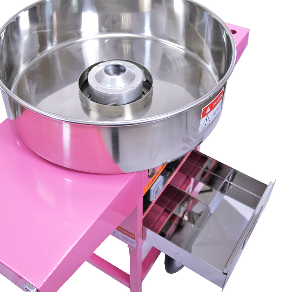Bright pink cotton candy machine with a shiny stainless steel bowl, featuring a central spinning head and a storage drawer below