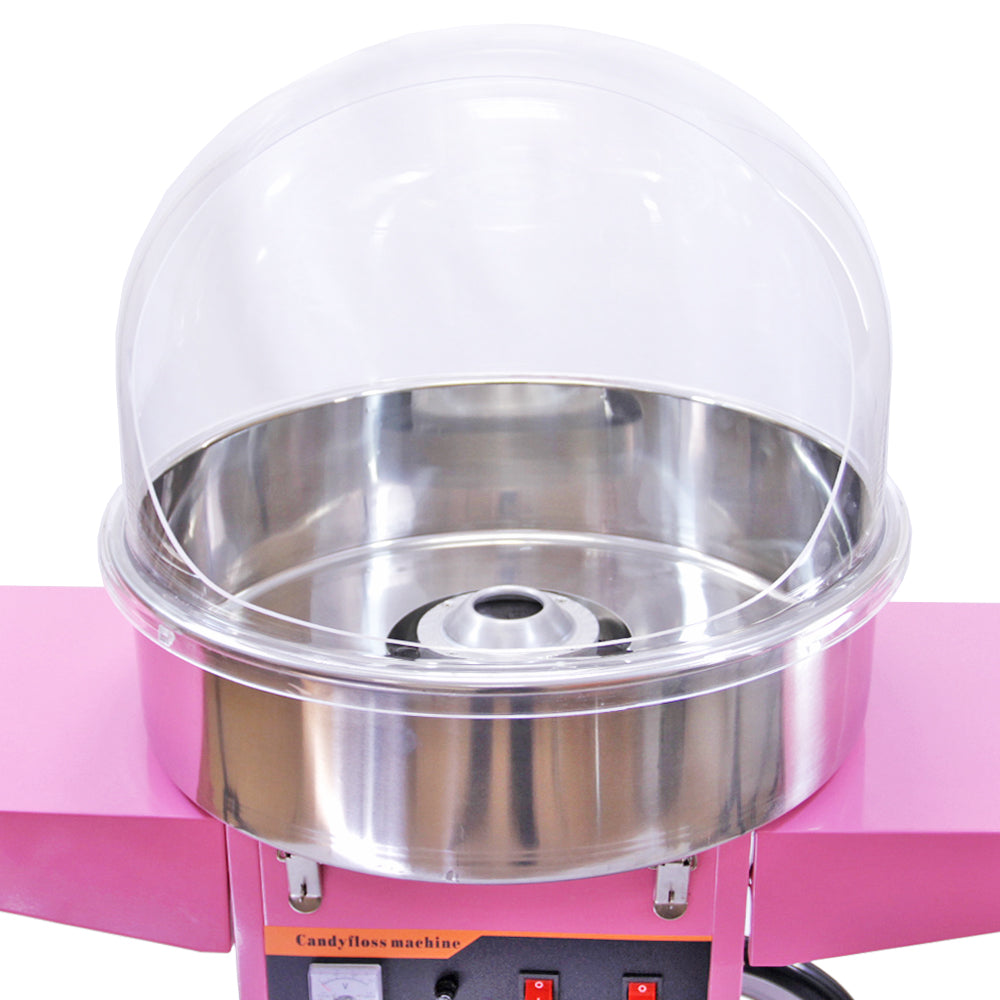 Bright pink candy floss machine with a shiny stainless steel bowl and clear plastic dome, designed for making fluffy cotton candy