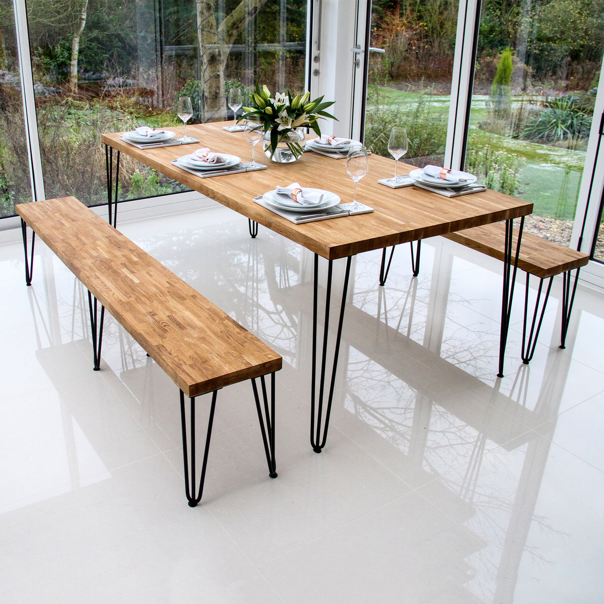 Grey 10mm hairpin leg feet protectors displayed on a modern wooden table with benches, enhancing stability and style