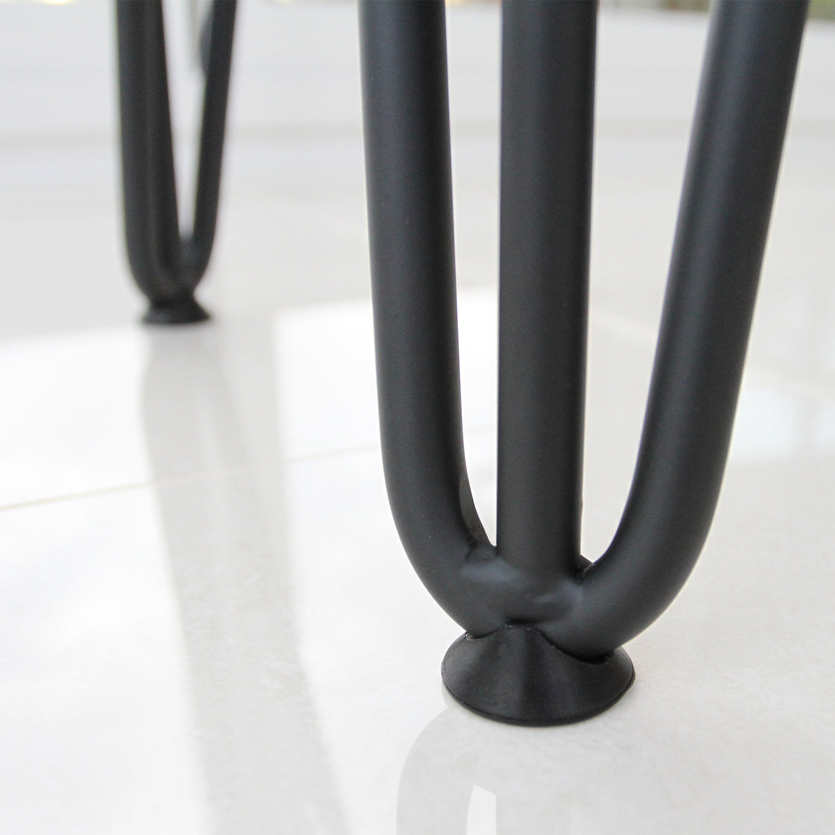 Black hairpin leg with a sleek 12mm design, featuring rounded feet protectors for stability on smooth surfaces
