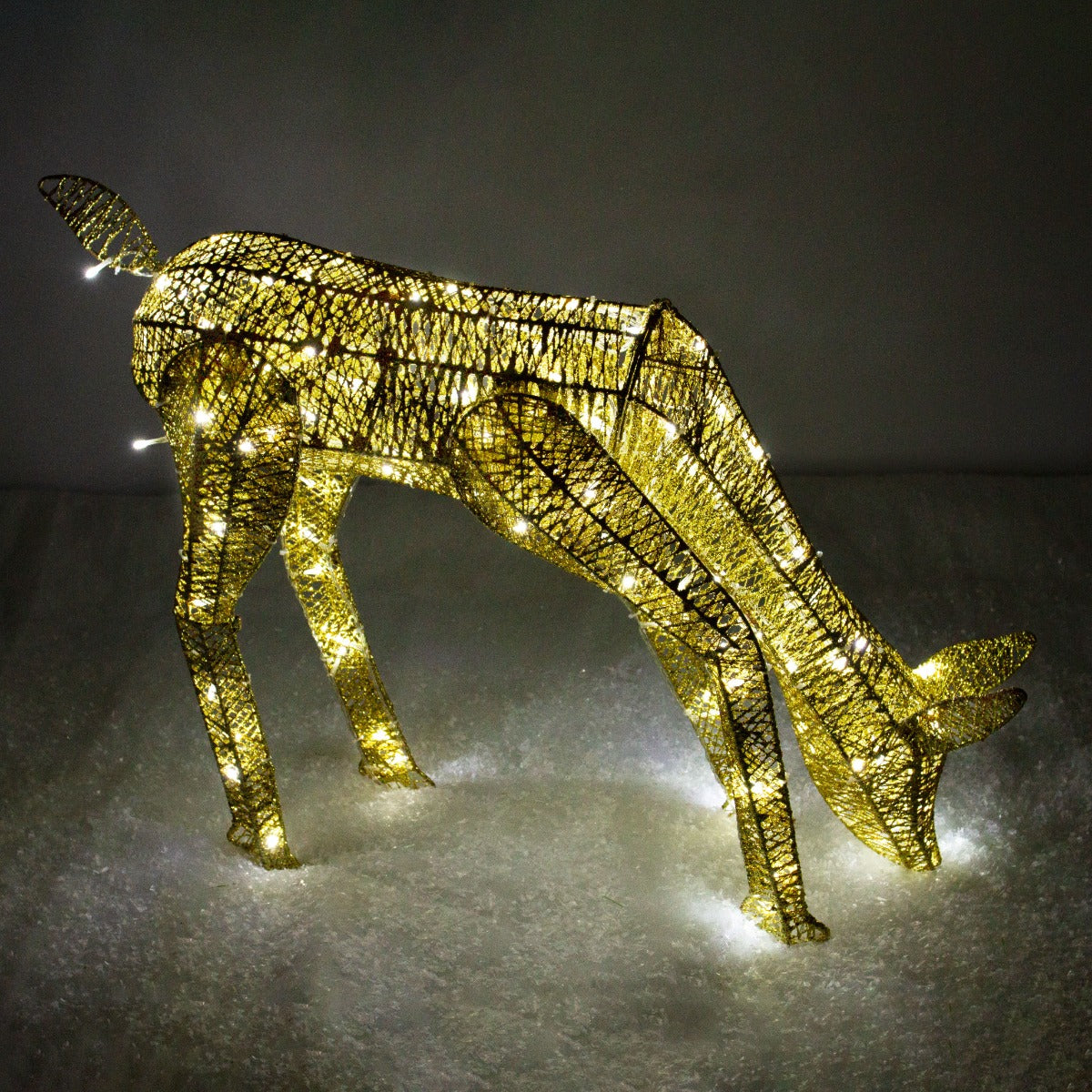 Gold stag and doe set with intricate wire design, illuminated by warm white lights, showcasing a festive, elegant holiday decor