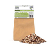 Applewood BBQ wood chips in a brown kraft bag, showcasing finely shredded wood pieces ideal for grilling and smoking flavor enhancement