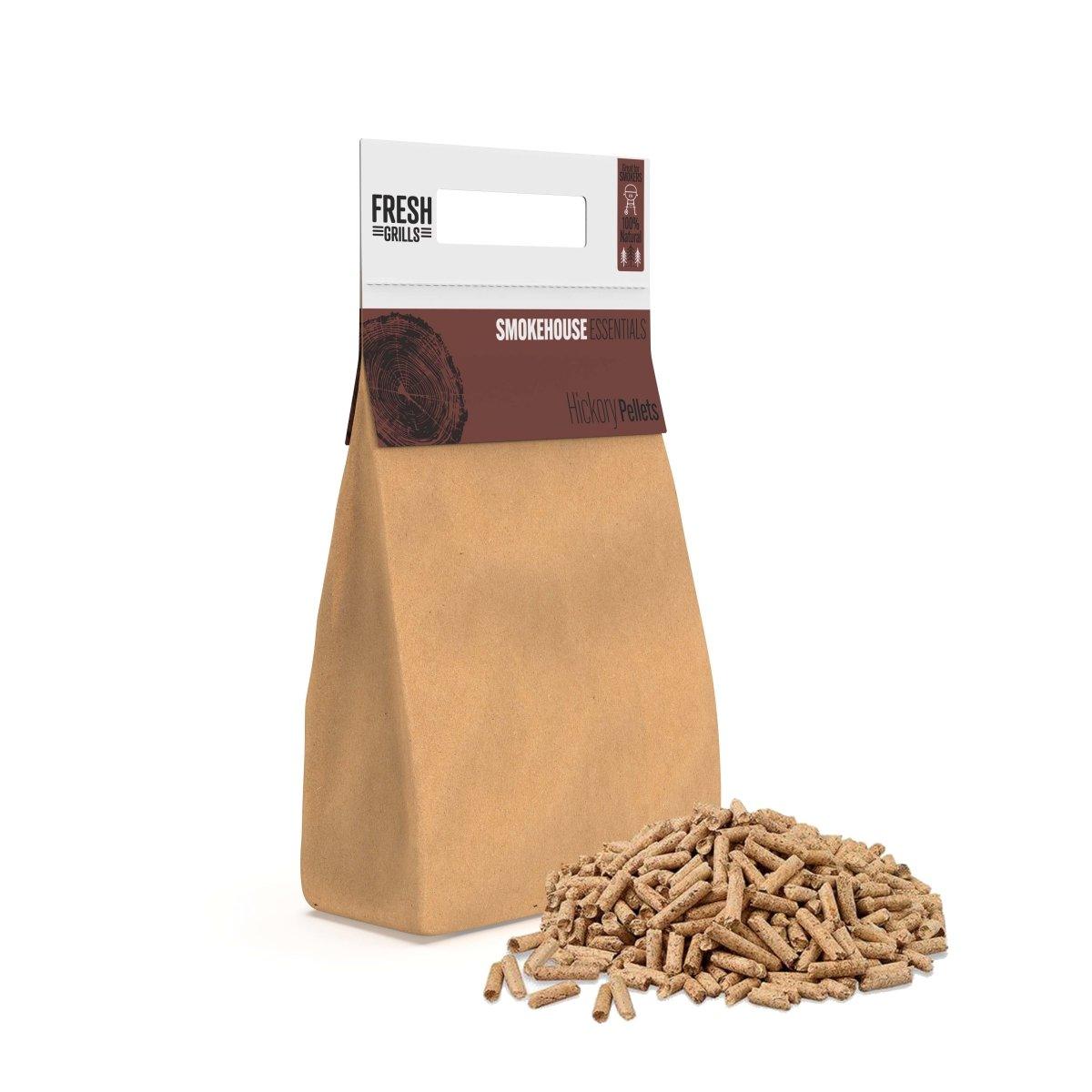 Hickory wood pellets in a brown paper bag, with a pile of pellets beside it, perfect for BBQ grills and outdoor smokers