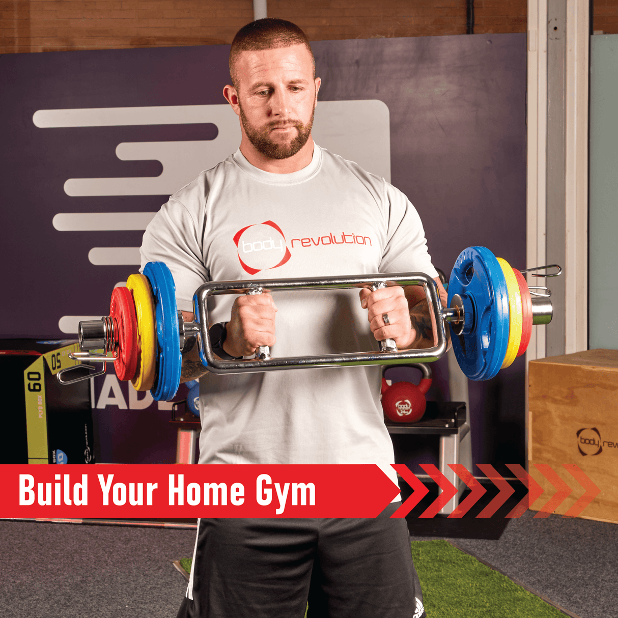 A man lifts a barbell with colorful Olympic tri-grip rubber weight plates in a gym setting, showcasing vibrant red, blue, and yellow colors